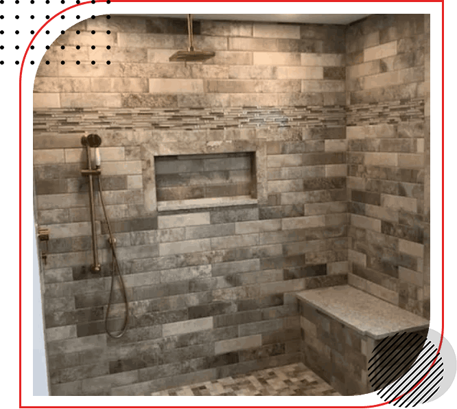 A tiled shower with a bench and shower head.