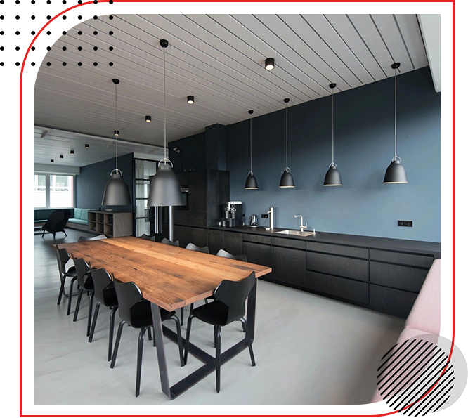 A kitchen with a wooden table and black chairs.