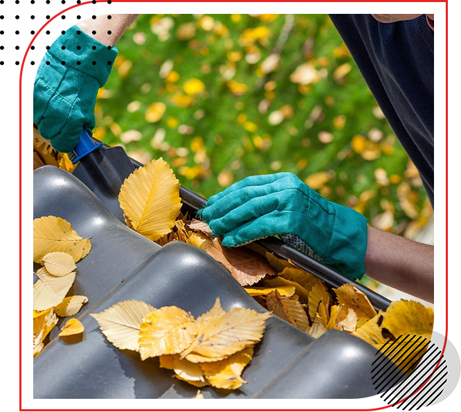 A person cleaning leaves on a roof.