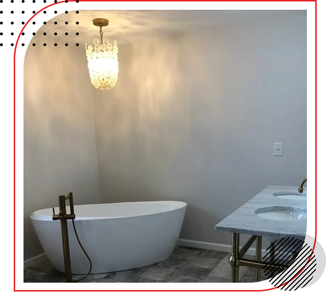 A bathroom with a bathtub and a chandelier.